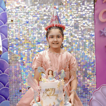 Girl celebrating her birthday with a cake at Wooray Ludhiana