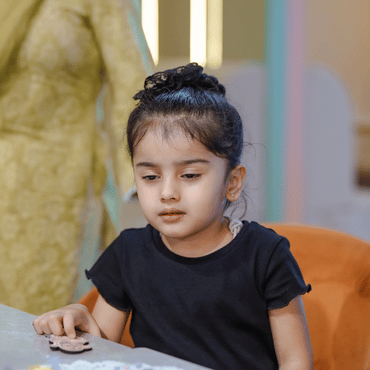 Girl enjoying a quiet creative activity at Wooray Ludhiana